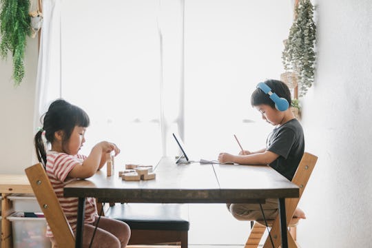 brother and sister sitting at table, homeschool