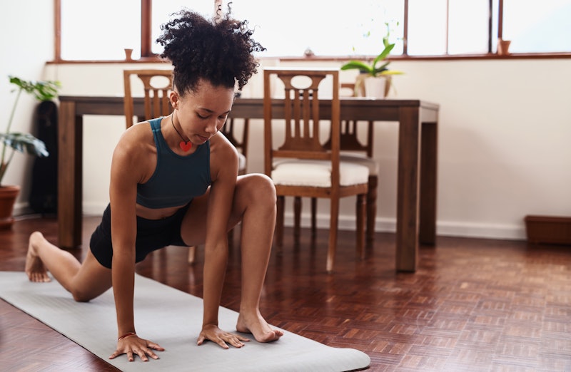 A woman does a lunch in her living room. These quiet workouts are good options for when your neighbo...