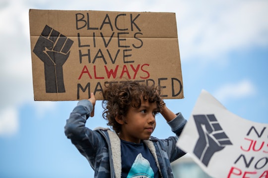 kid holding black lives matter sign