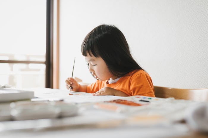 little girl painting at home