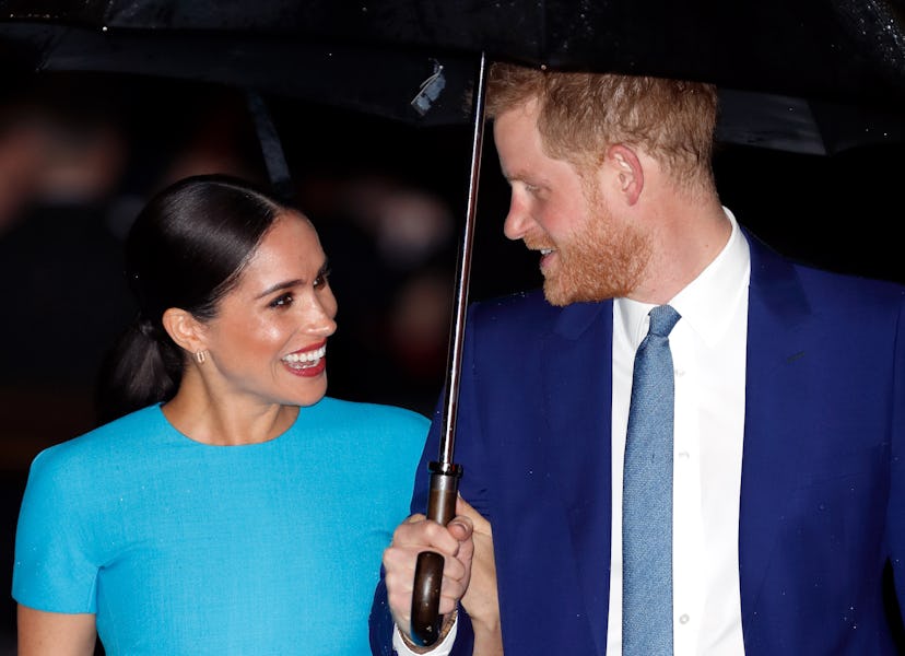 Meghan Markle and Prince Harry staying dry in March 2020.