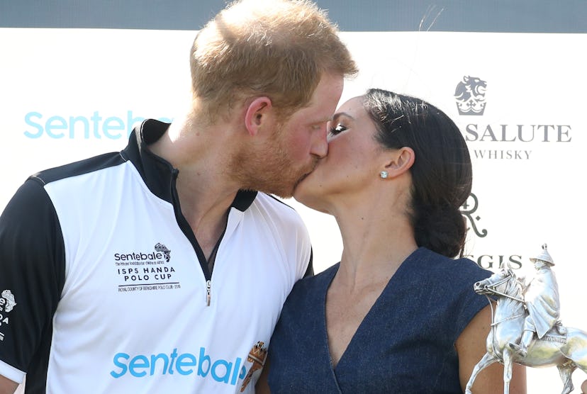 Meghan Markle plants a kiss on her husband.