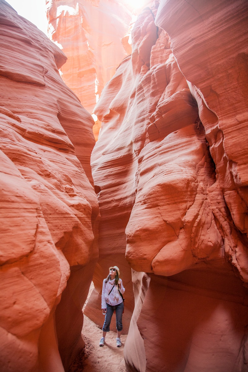 A woman inside antelope canyon. Unplugging from technology has myriad health and wellness benefits, ...