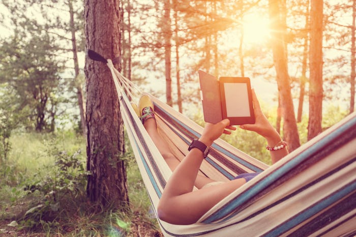 woman in hammock with e-reader