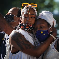 Two people embrace at a Black Lives Matter protest. Experts explain how to recharge from burnout aft...