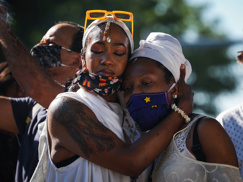 Two people embrace at a Black Lives Matter protest. Experts explain how to recharge from burnout aft...