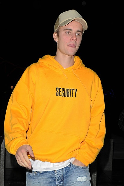 Justin Bieber steps out in a vivid yellow sweatshirt.