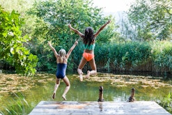 kids jumping into pond