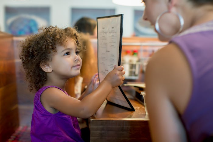 mother and daughter ordering in restaurant