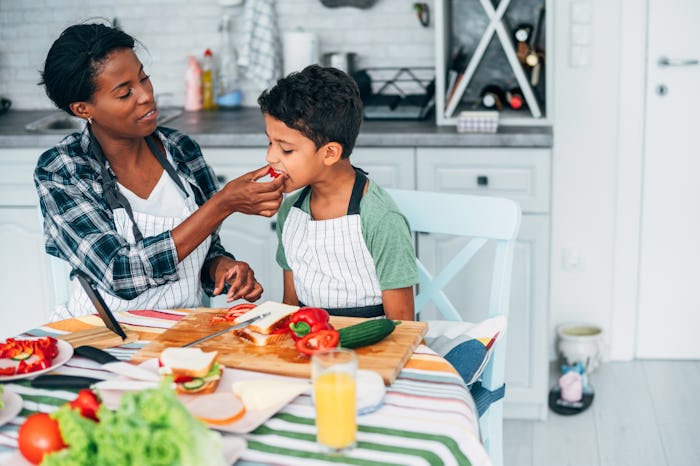 mom and son meal prepping school lunches in kitchen