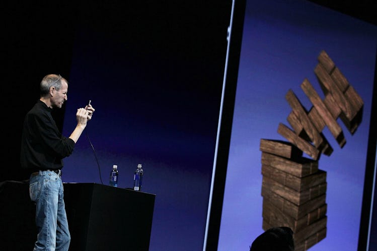 Steve Jobs playing a game of Jenga on an iPhone.