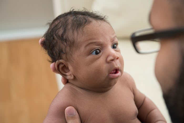 baby looking at dad
