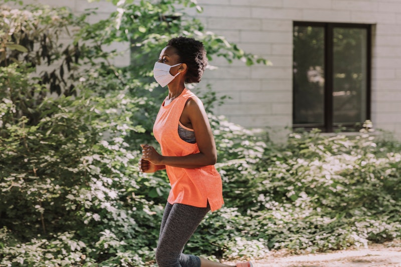 A woman goes for a run wearing a face mask. What kinds of masks are most effective? A new study shed...