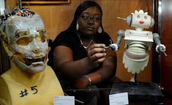 A woman making a model of Rosie the Robot from The Jetsons.