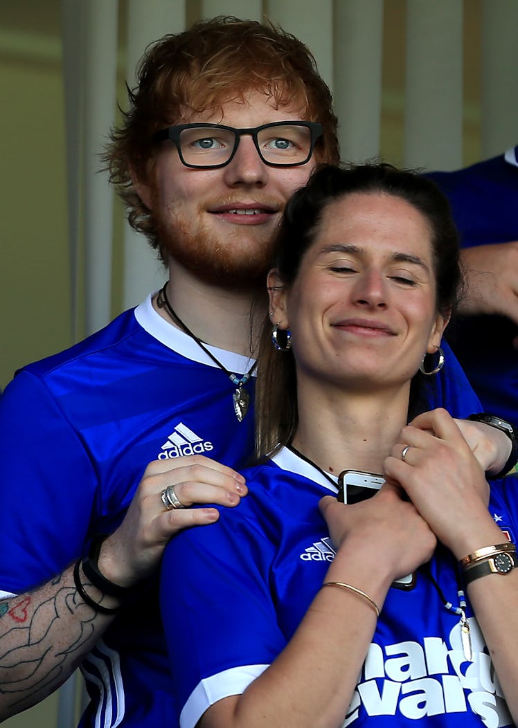 Ed Sheeran and wife Cherry Seaborn attend a sports game.