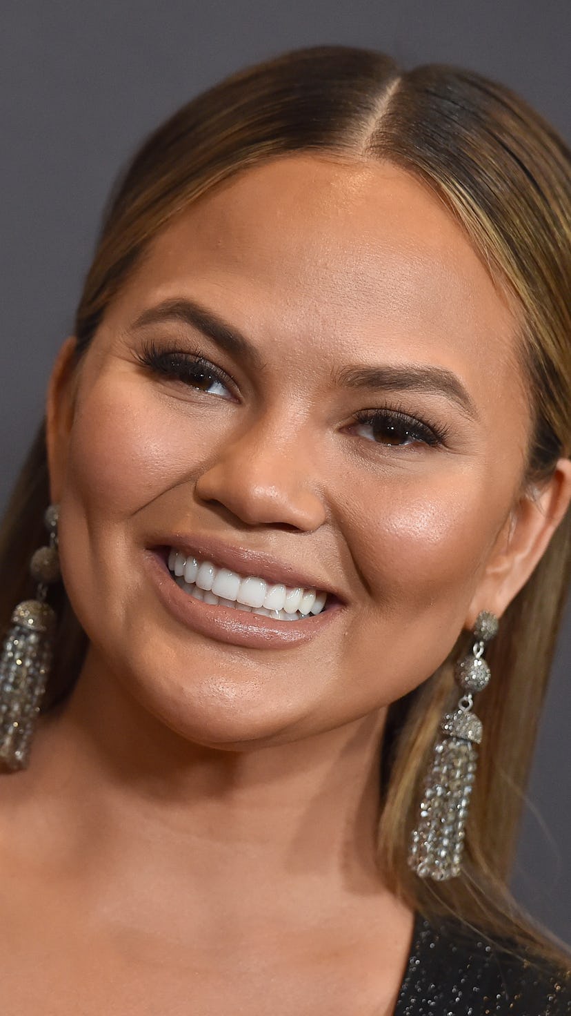Chrissy Teigen poses on the red carpet