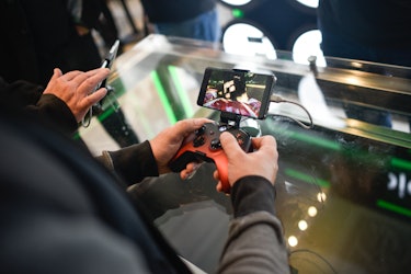 A gamer playing Xbox through an Android phone.