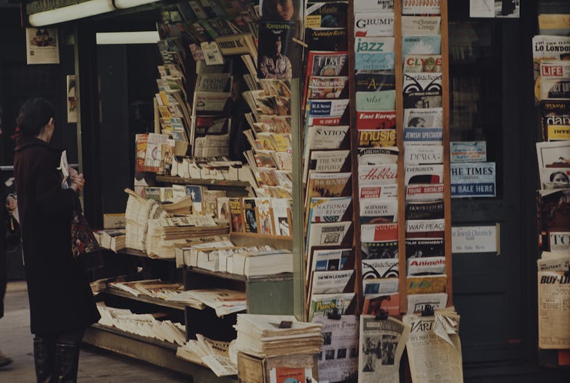 Close-up of a news stand with magazines and newspapers.
