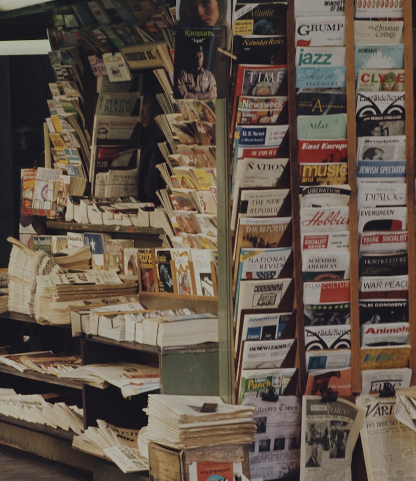Close-up of a news stand with magazines and newspapers.