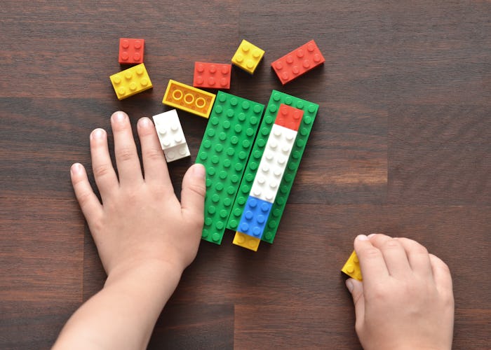 kid hands playing legos
