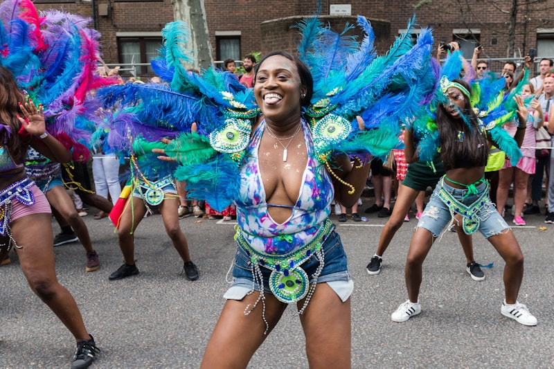 A female dancer at Notting Hill Carnival in a blue costume