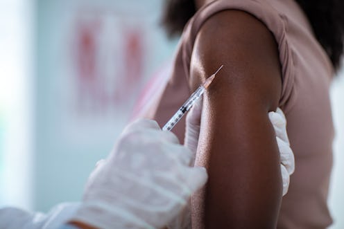 A doctor gives a patient a flu shot. Getting your flu shot during COVID is especially important.