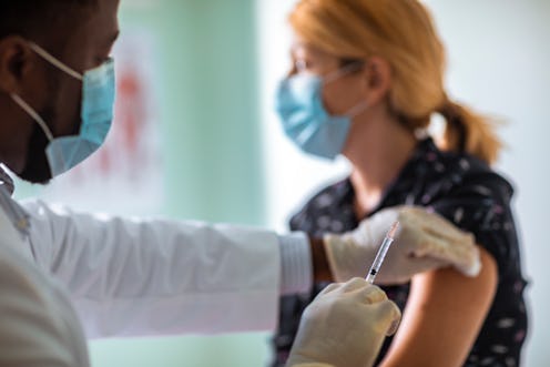 A young woman getting her flu shot during COVID