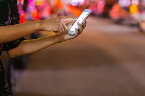 A woman hails a ride on her phone. Are Lyft & Uber shutting down in california? a state law is causi...