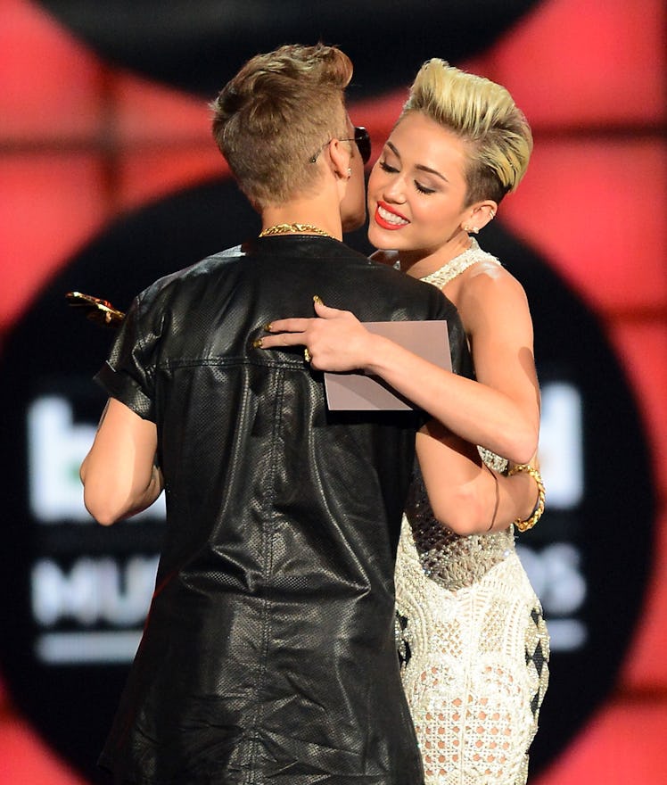 Justin Bieber and Miley Cyrus share a hug.