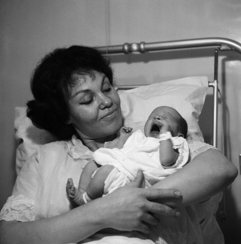 The proud mom in this vintage maternity ward photo proves that motherhood is timeless. 