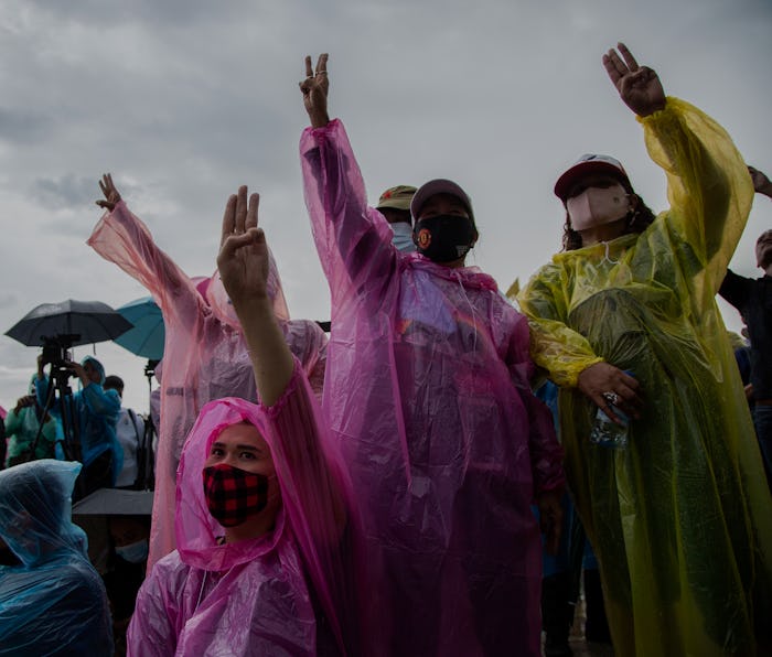 Protestors in colorful rain gear protest in Bankok.