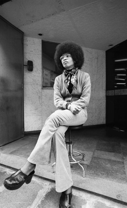 Angela Davis wears cardigan, turtleneck, and clogs in the 1970s.