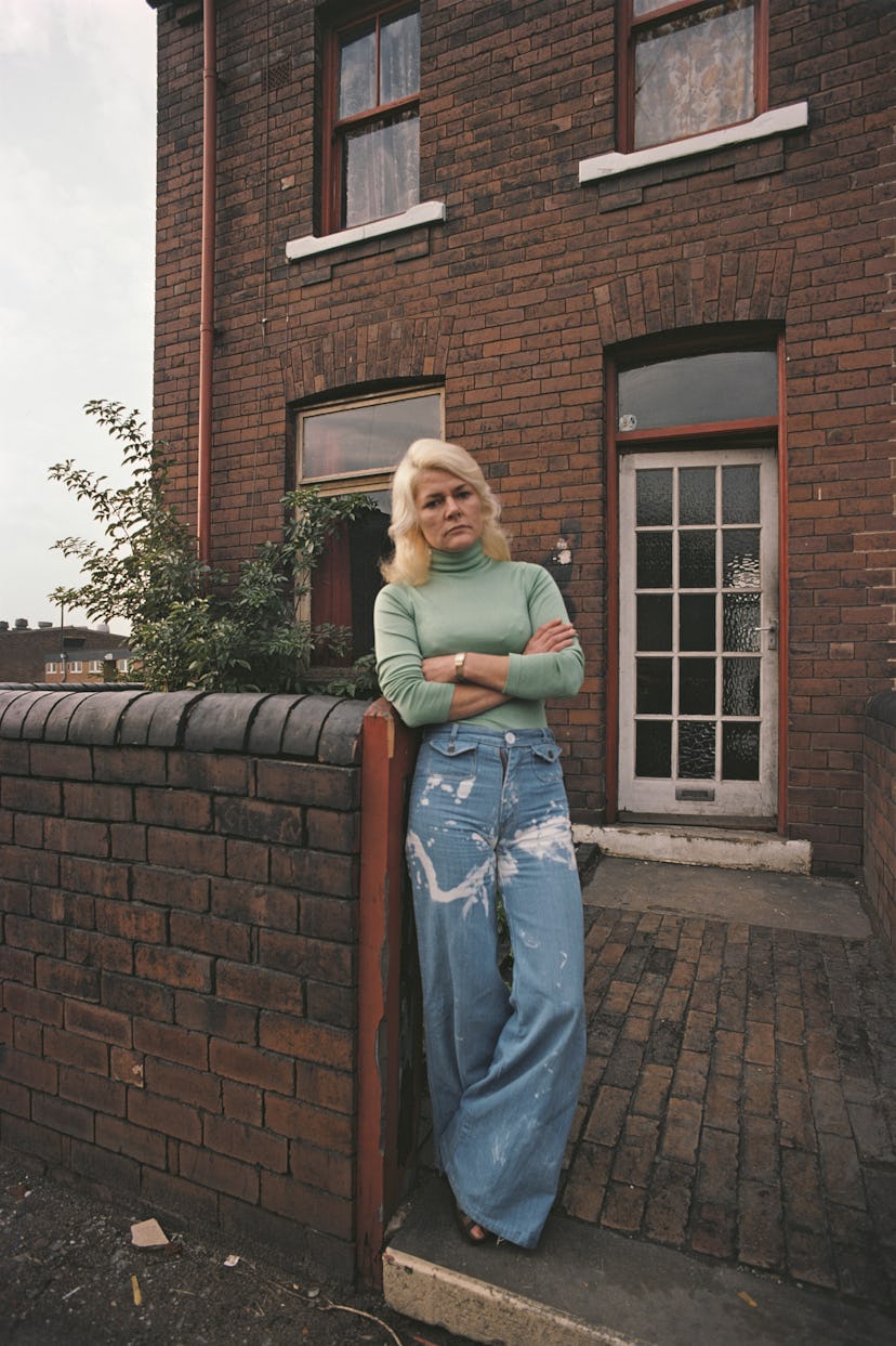 70s denim: Woman wears a colorful turtleneck and wide leg jeans in the 1970s.