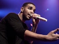 Drake singing with a microphone on his concert