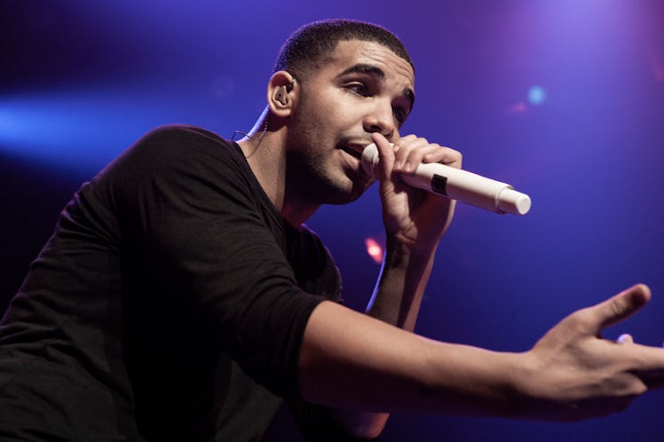 Drake singing with a microphone on his concert