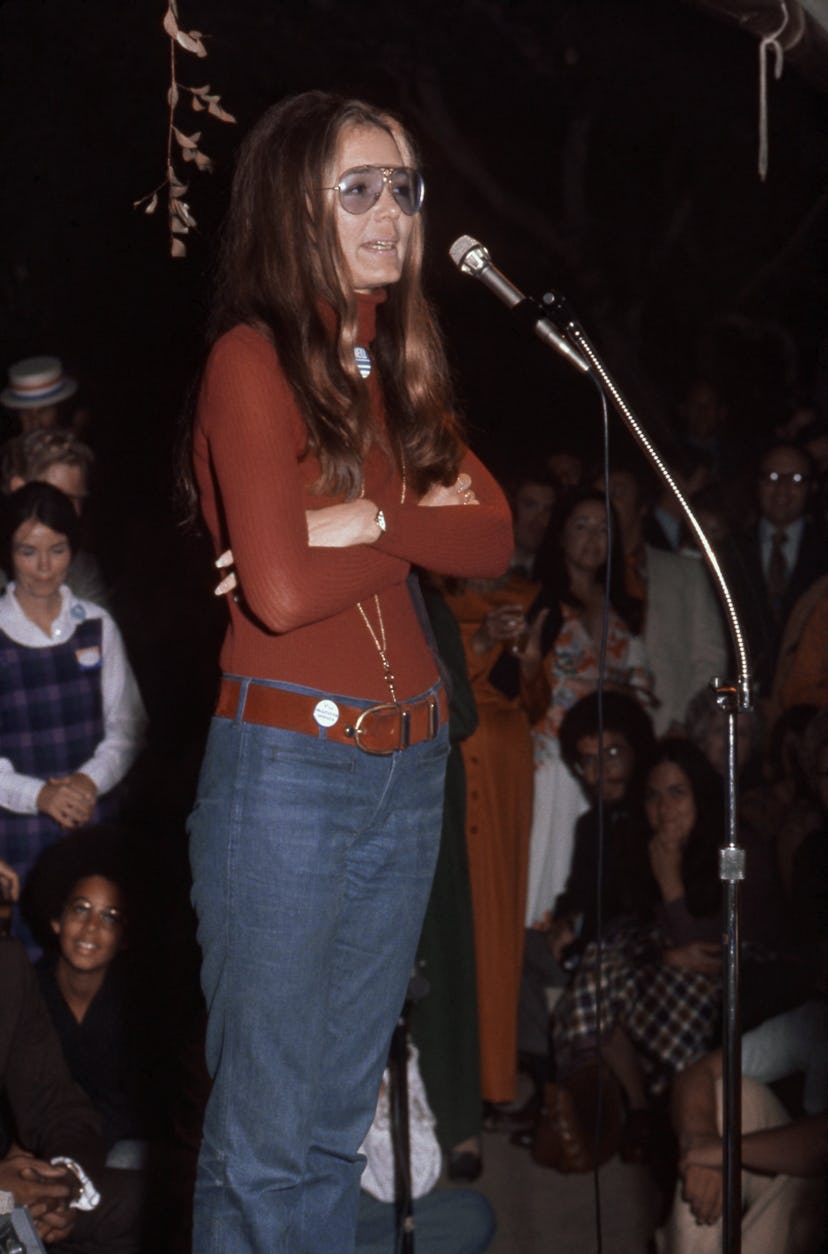 70s denim: Gloria Steinem wears a fitted turtleneck top with dark jeans in the 1970s.
