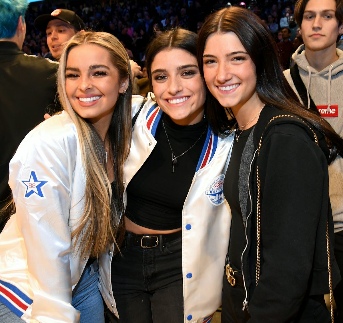 Addison Rae, Dixie D'Amelio, and Charli D'Amelio, attend a basketball game.