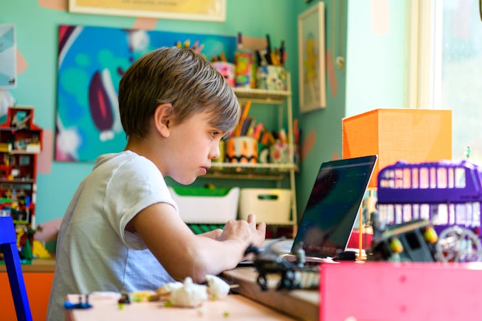 Child sitting in front of computer, remote learning from home