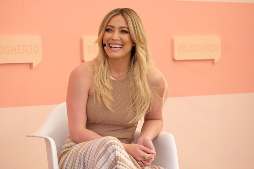 Hilary Duff with curtain bangs on her long, blonde, layered balayage. 