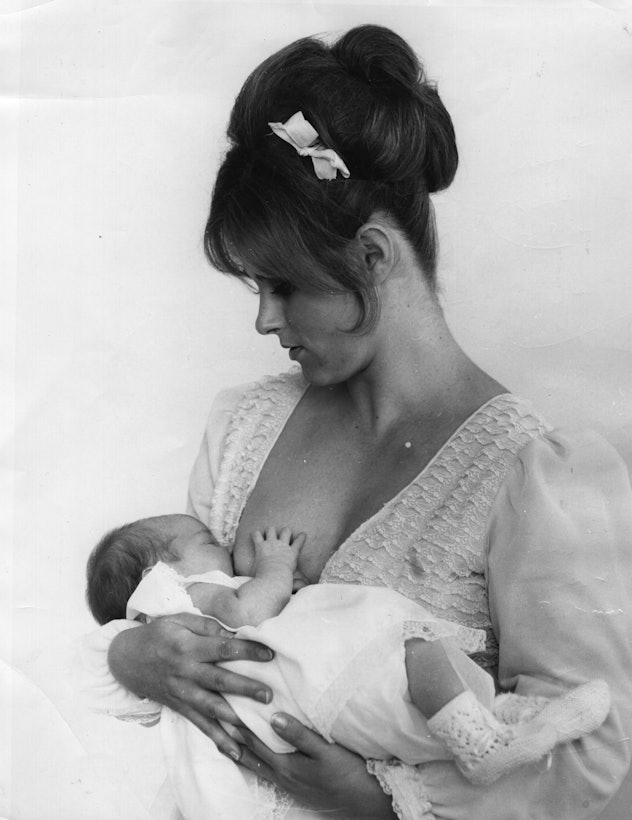 vintage 1970s photo of woman breastfeeding child