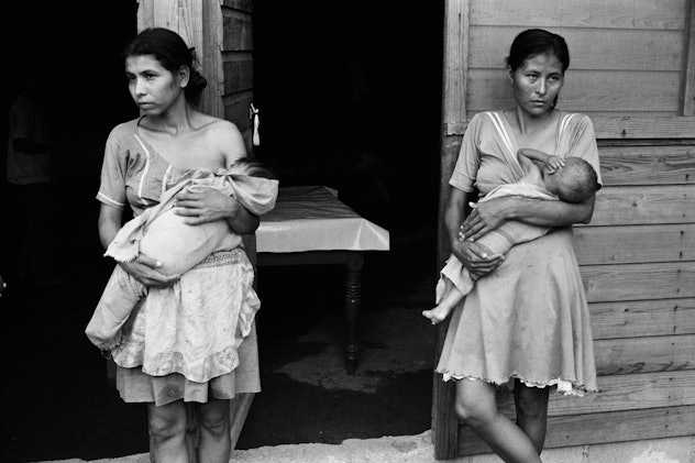 two women breastfeeding their children in an El Salvadoran refugee camp in 1981