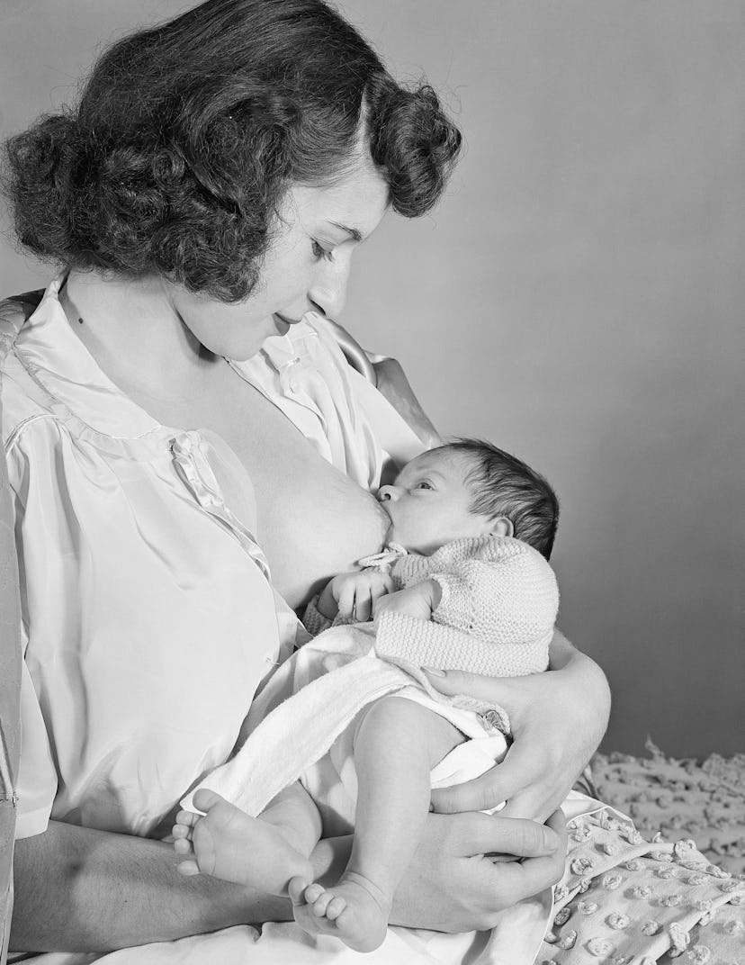 1950s photo sof woman nursing 5 month old infant