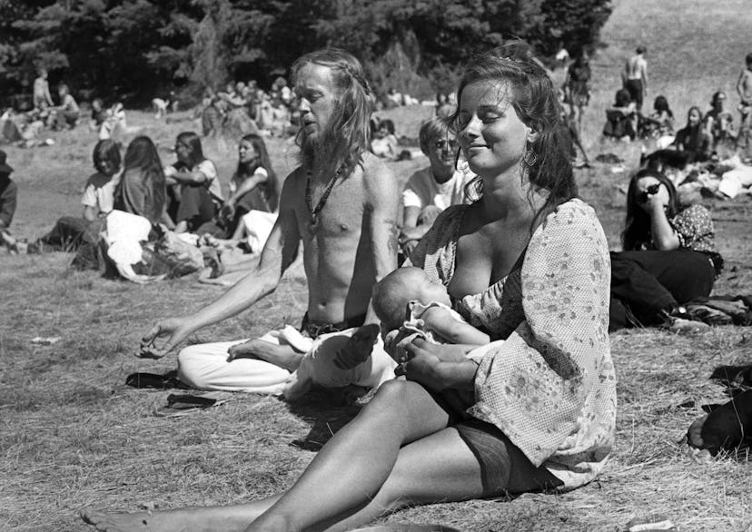 black and white photo of woman breastfeeding at park in San Francisco, California 