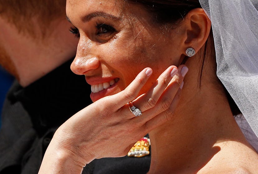 Markle wore two shades of light pink on her nails and a warmer pinky taupe on her toenails for her w...