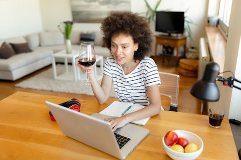 A woman drinks wine at her laptop. These doctor-recommended ways to improve your memory can help you...