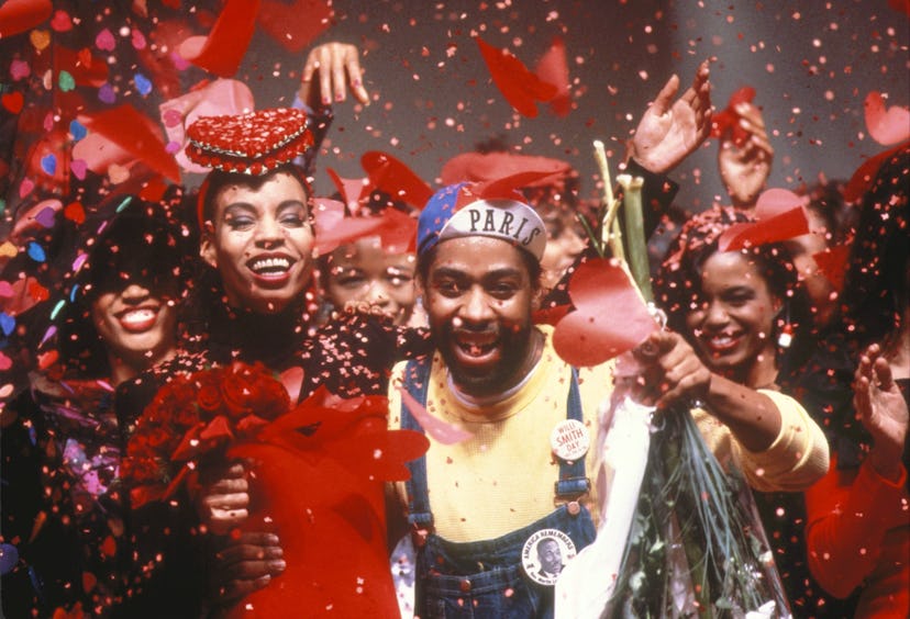 A group of Black activists during a party celebration, wearing denim clothes with red confetti in th...