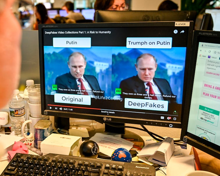 Russian leader Vladimir Putin is seen on two screens. The title above one screen reads "Putin" and i...