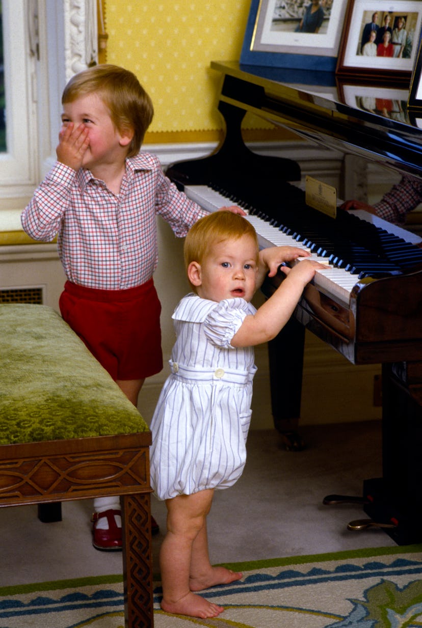 Prince William gets a kick out of brother Harry in the Kensington Palace playroom.