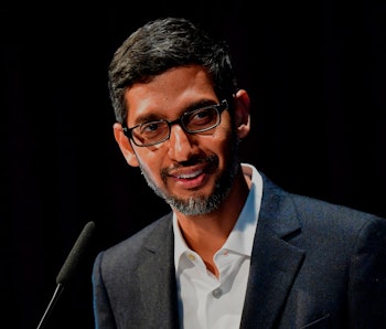 Google CEO Sundar Pichai can be seen talking to an audience. The background behind Pichai is black. ...