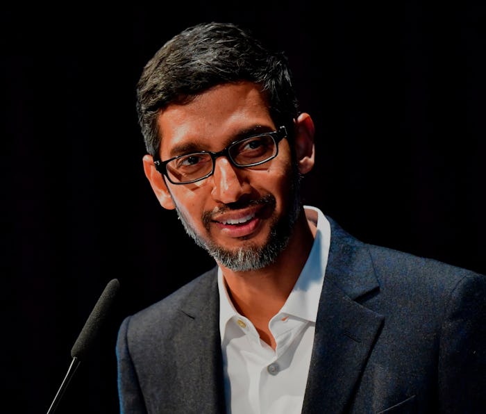 Google CEO Sundar Pichai can be seen talking to an audience. The background behind Pichai is black. ...